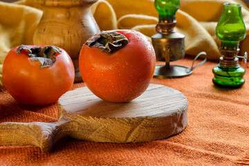 Juicy persimmon on a wooden Board