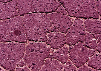 Pink toned damaged asphalt road texture.