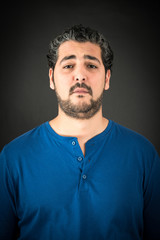 Obraz premium Handsome man doing different expressions in different sets of clothes: sad