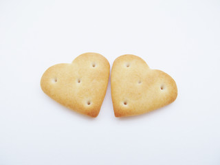 
Two cookies in the shape of a heart on a light background