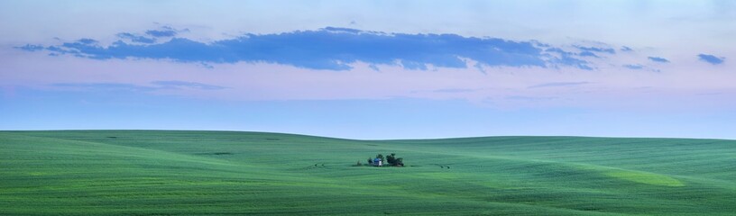 Obraz premium panorama with little farm house with last sun lights in green field