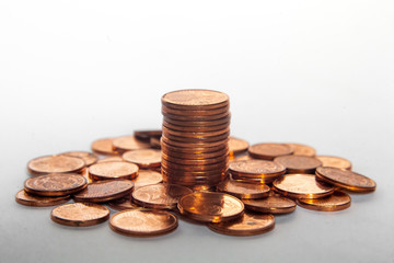 pile of coins and a coin stack between it white background