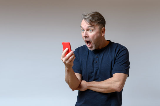 Man Looking At His Mobile In Shock And Horror