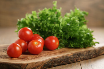 cherry tomatoes and frisee lettuce on cutting board