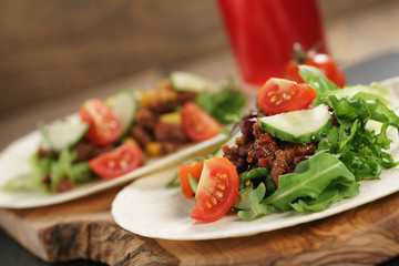 homemade open tortilla sandwich with beef, frisee, beans and corn