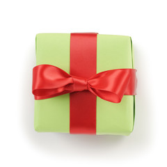 green paper gift box with red ribbon bow top view on white background