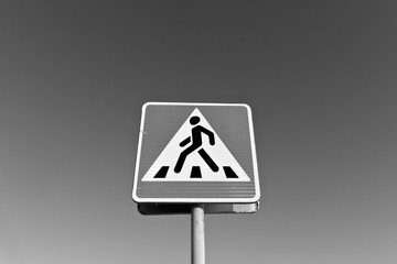 Metal pedestrian sign in black and white