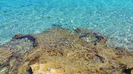 Bright turquoise sea water and coastal rocks