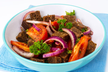 Simple salad with bread, tomato, red onion, vegetable oi