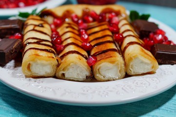 Pancakes with cottage cheese, chocolate sauce, whole grains pomegranate and chocolate cubes. Tasty...