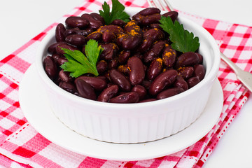 Beans, spices and curry in white salad bowl