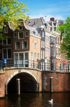 old housesand historical bridge over canal, Amsterdam, Netherlands, retro toned