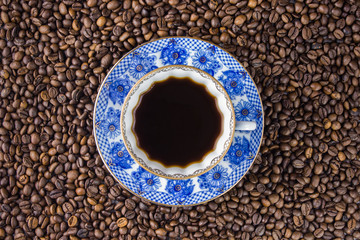 Coffee cup and saucer on a wooden table. Dark background.