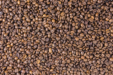 Coffee beans on wooden background are  the table top view concept