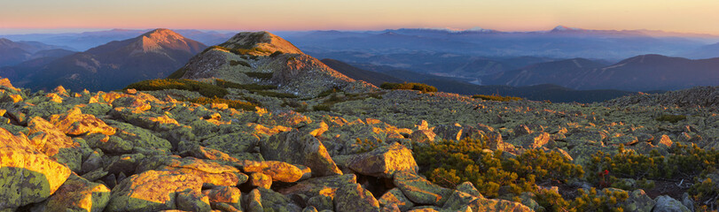 Evening Carpathian mountains. in the foreground a lot of stones,