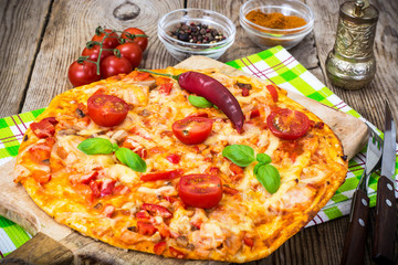 Pizza with prosciutto,mushroom and tomatoes