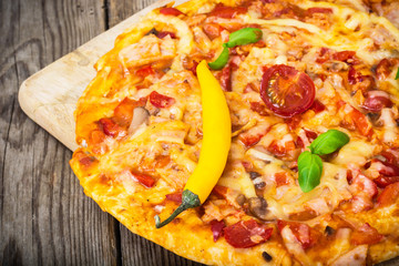 Pizza with prosciutto,mushroom and tomatoes