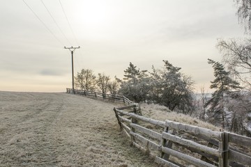 Winter sunrise landscape photo with electric line