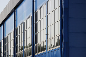 Obraz premium large sports complex. big blue building with many windows.