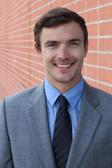 Portrait of handsome cheerful young smiling businessman