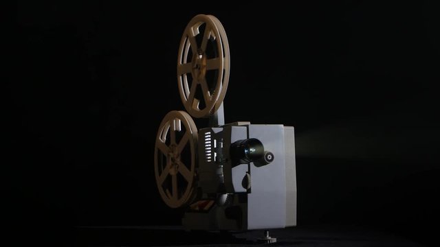 In the studio shows movie in a projector. Black background