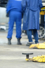 Yellow close up lift's arms in a car repair station