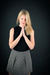 Fototapeta premium Beautiful woman doing different expressions in different sets of clothes: prayer
