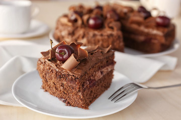 Fototapeta na wymiar Delicious chocolate cake with cherry on plate