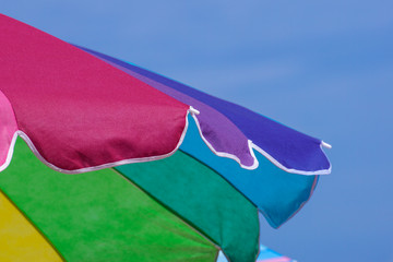 Close up of a colorful beach umbrella. Useful as cover art or background.