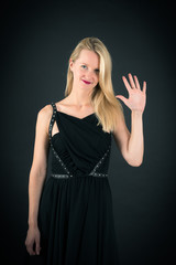 Fototapeta premium Beautiful woman doing different expressions in different sets of clothes: wave