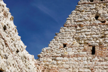 Fortress wall against the blue sky .