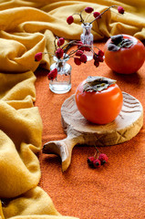 Juicy persimmon on a yellow background