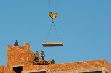 Builders making wall of new building