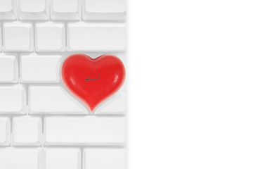 White apple computer keyboard with a red love heart shaped return key
