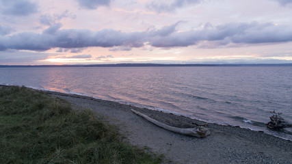 Golden Gardens Ballard Seattle, Washington Purple and Red Clouds Sunset Beach Shoreline Driftwood and Waves