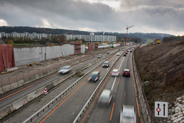 Automobile traffic on a highway under construction. Motion blurred image.