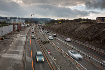 Fototapeta na wymiar Automobile traffic on a highway under construction. Motion blurred image.