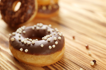 Tasty donuts on wooden table