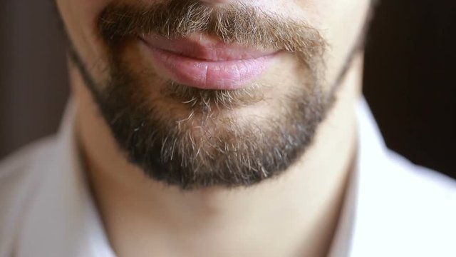 The man's smile.A man with a beard smiling. Close-up. sexy lips