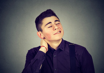 Young man having neck pain