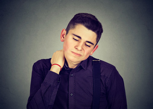 Young man having neck pain