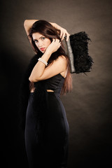 woman evening dress handbag in hand on black