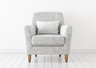 Empty white pillow mock-up with neutral velvet armchair on wooden floor. 3D rendering.