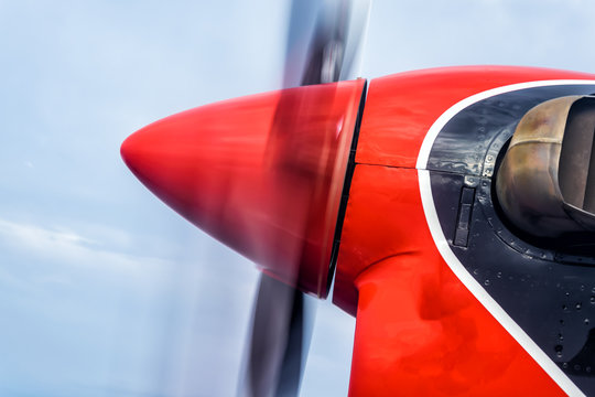 Red colored motor of a water plane in action flying over the indian ocean, near Maldives.