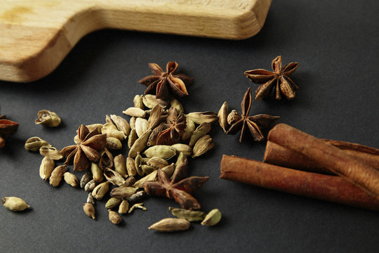 Anise and cardamom and cinnamon on black background. Mixed spice