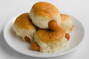 Stuffed Hot Dog Buns In White Plate.