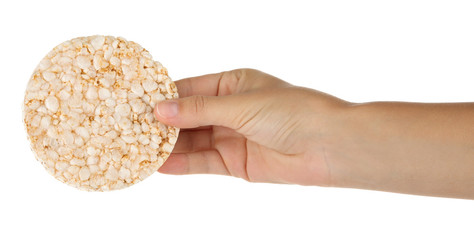 Female hand holding rice cracker on white background