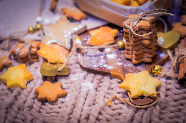 Gingerbread and sugar stars cookies on knitted background