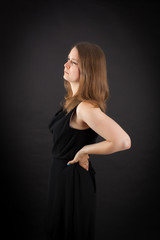 Fototapeta premium Beautiful woman doing different expressions in different sets of clothes: backache