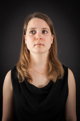 Beautiful woman doing different expressions in different sets of clothes: thinking